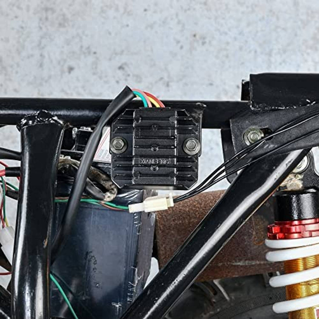 Black regulator rectifier close-up with finned heat sink and colored wire leads