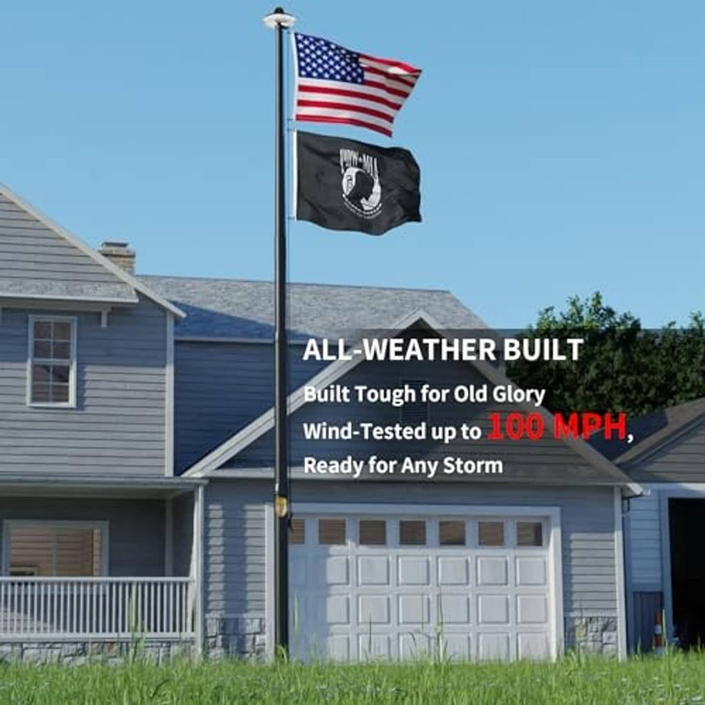 Black outdoor flag pole with solar light top and attached flags on a yard