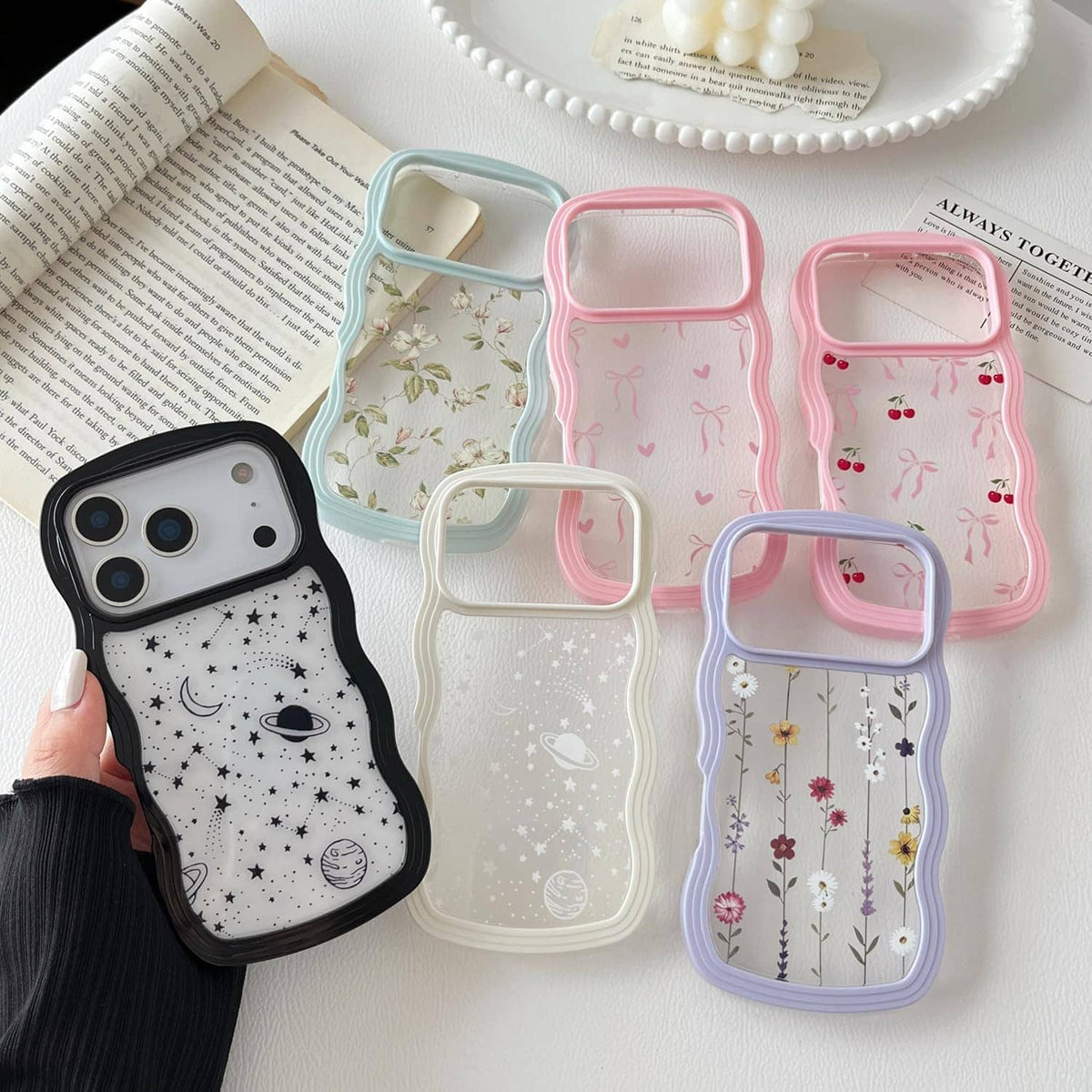 Set of iPhone Pro Max cases with space patterns in pastel colors, various frame colors