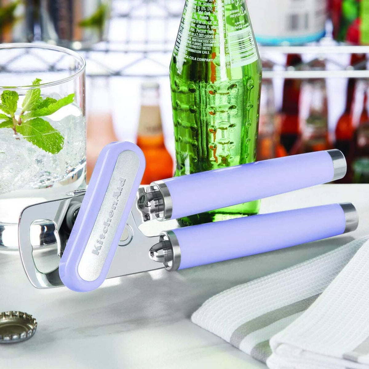 Lavender can and bottle opener with stainless steel cutting wheel on countertop.