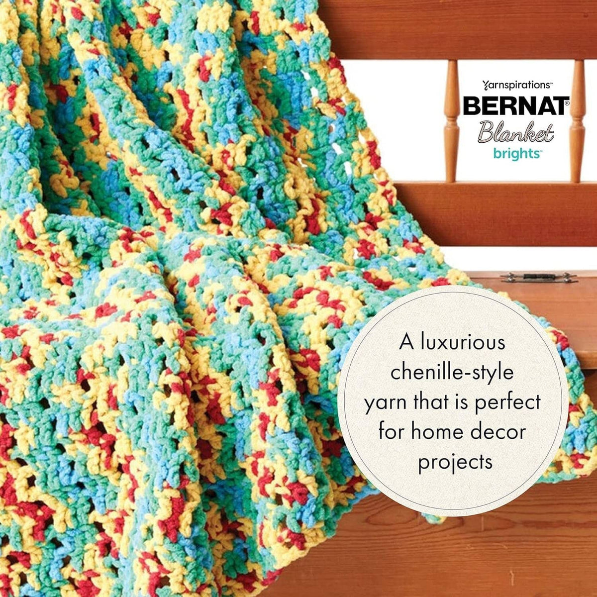 Multicolor chenille-style crochet blanket in blue, yellow, pink, and teal