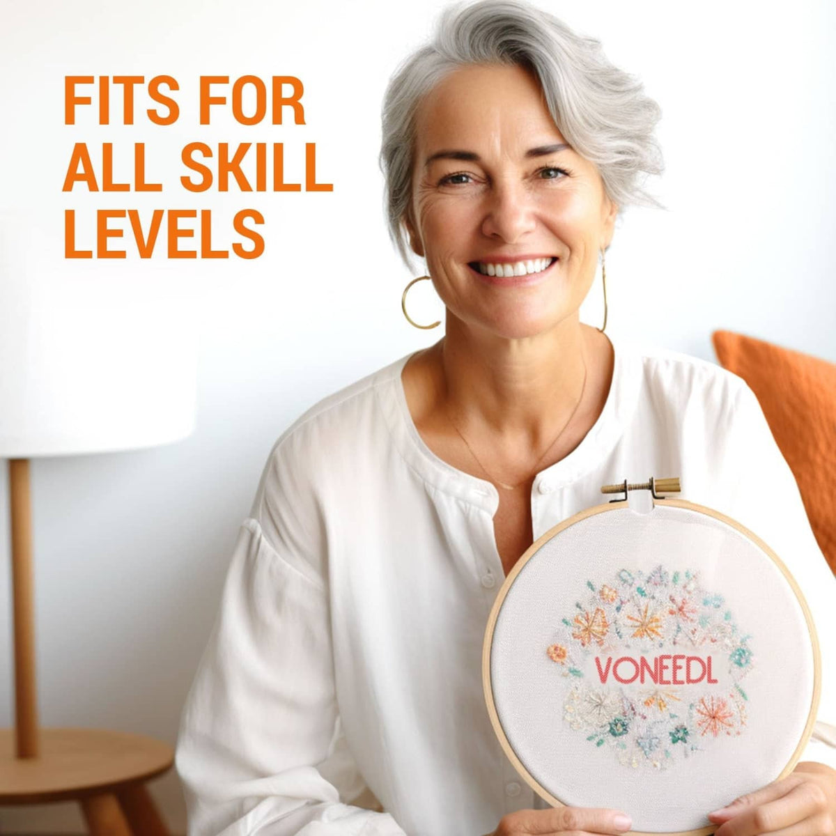 Person holding an embroidery hoop while using large-eye sewing needles