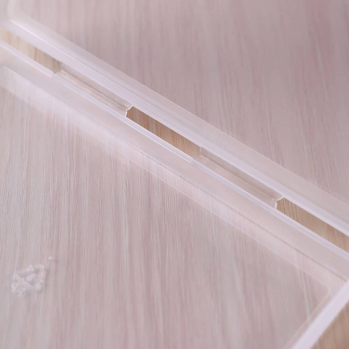 Clear plastic storage box lid edge with locking bar and ridged hinge
