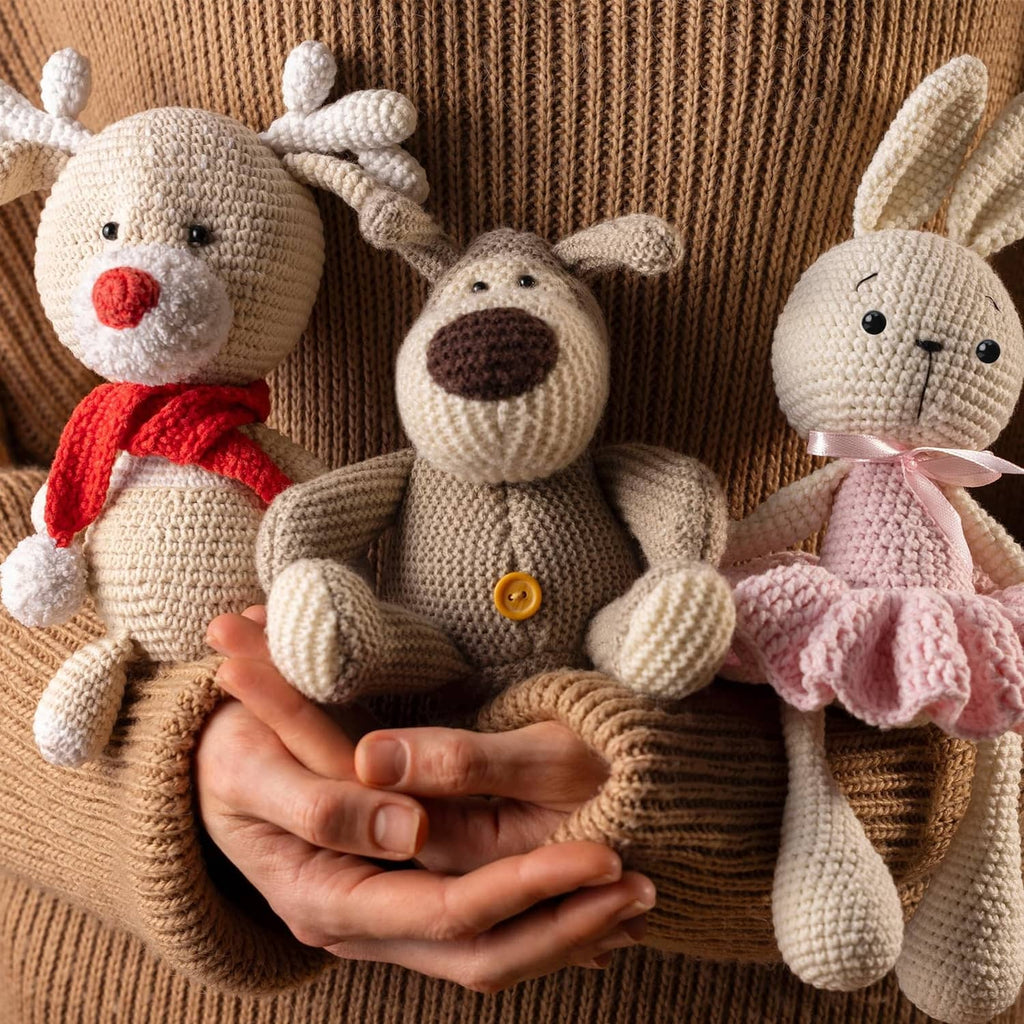 Crocheted plush animals wearing black safety eyes and stitched noses