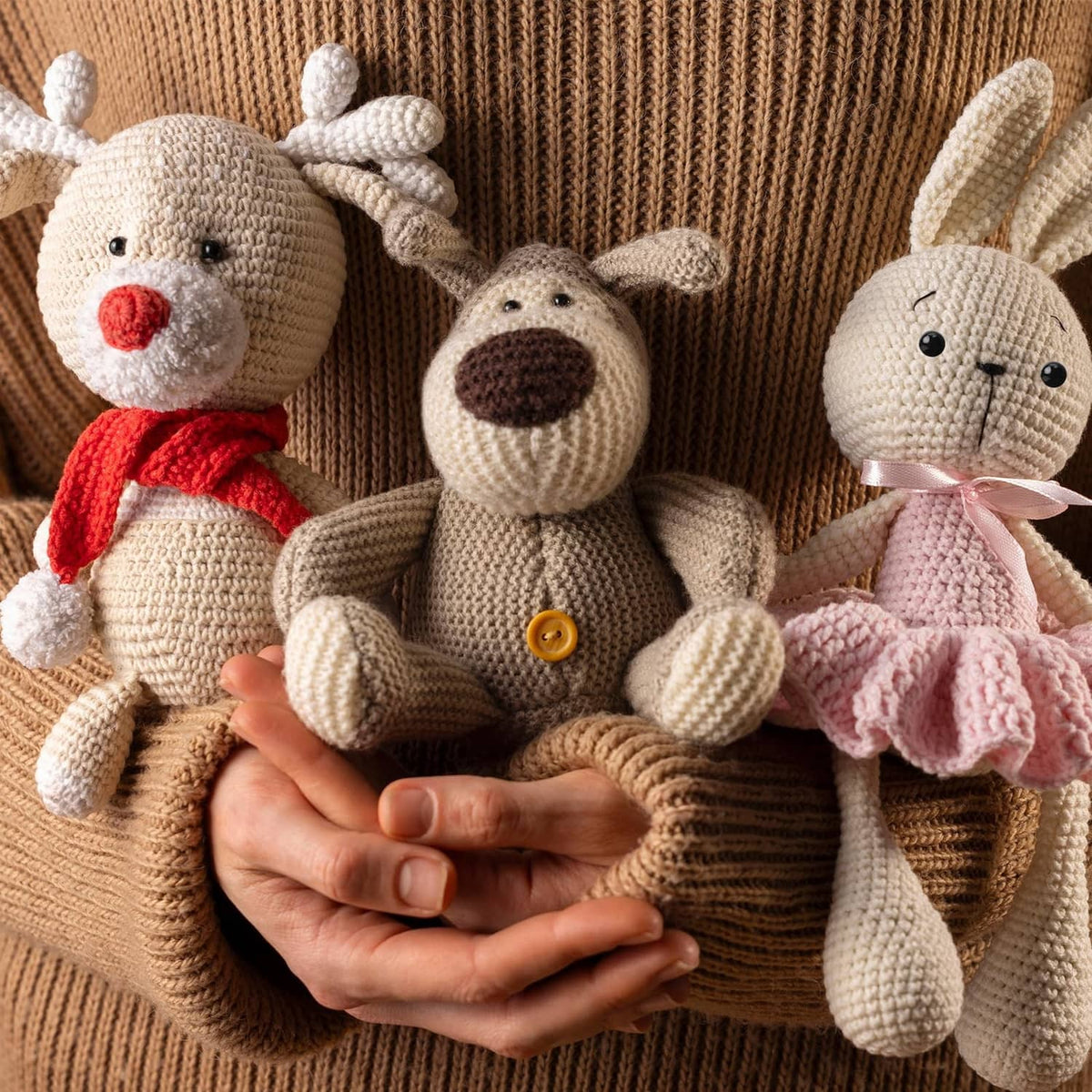 Crocheted plush animals wearing black safety eyes and stitched noses
