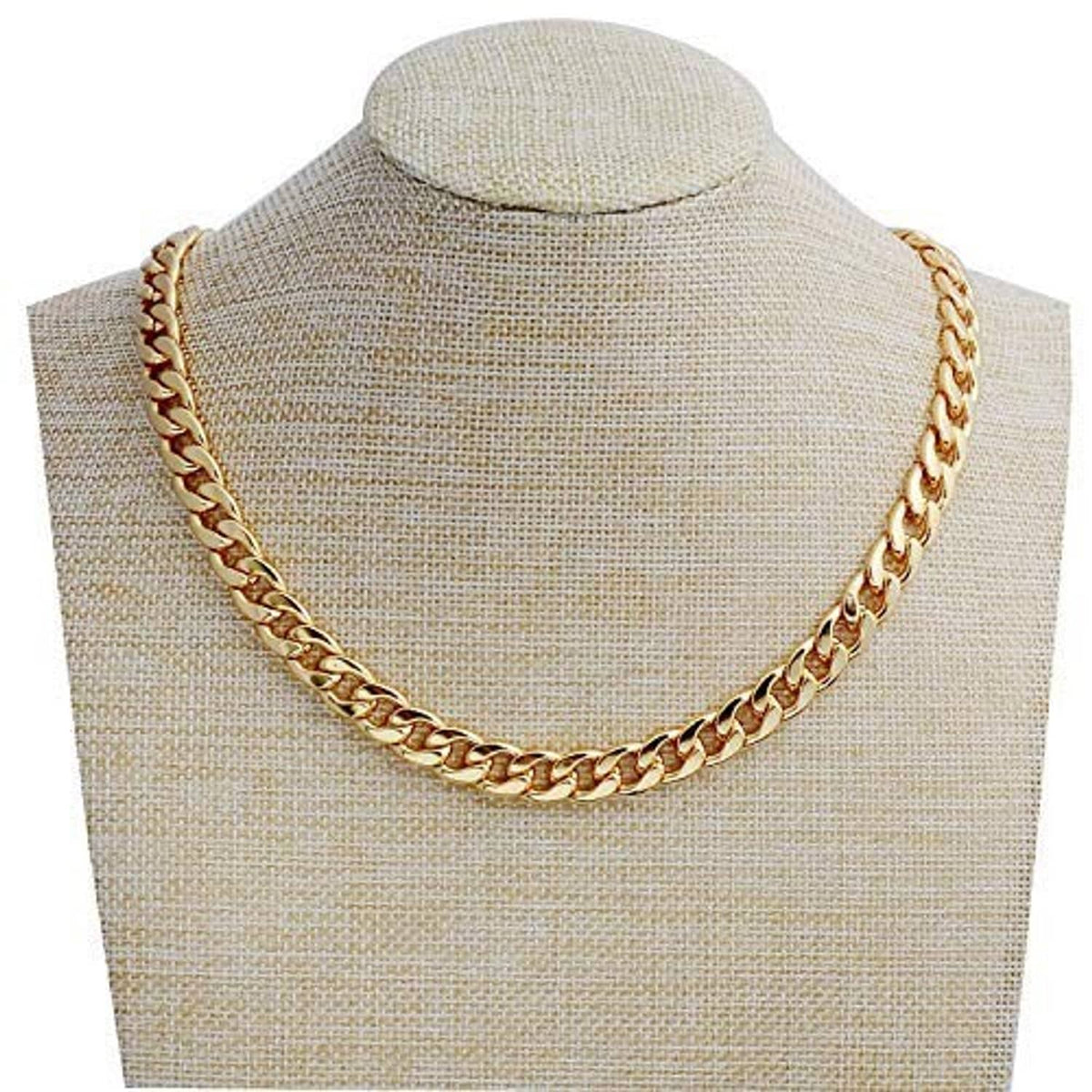 Gold chain necklace with chunky curb links on a beige display bust