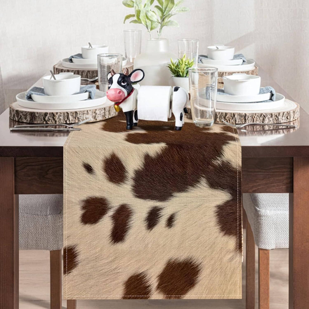 Cow print table runner centered on dining table, brown and white spots
