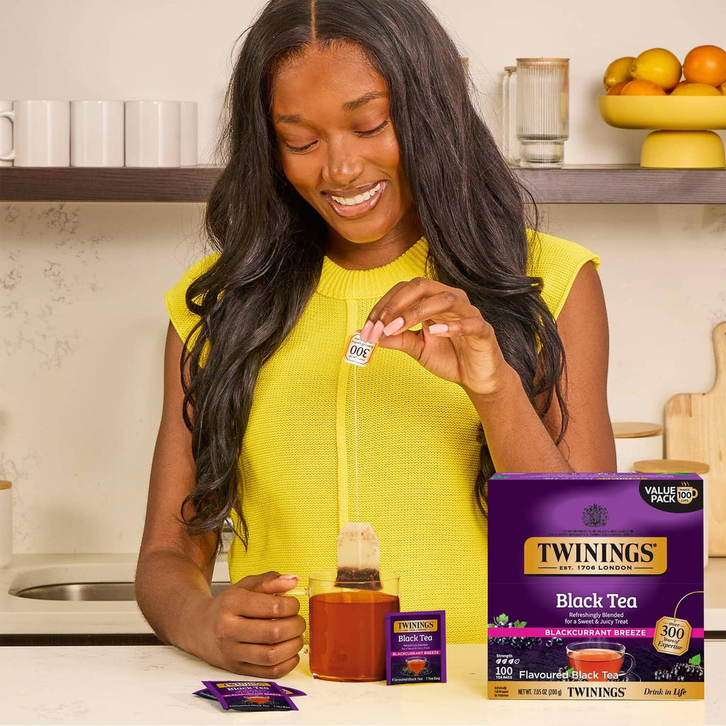 Twinings Blackcurrant Breeze tea bags with boxed tea and a brewed cup