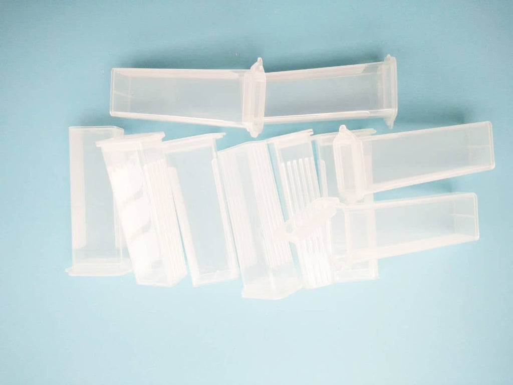 Clear plastic microscope slide holder box with several compartments for rectangular slides