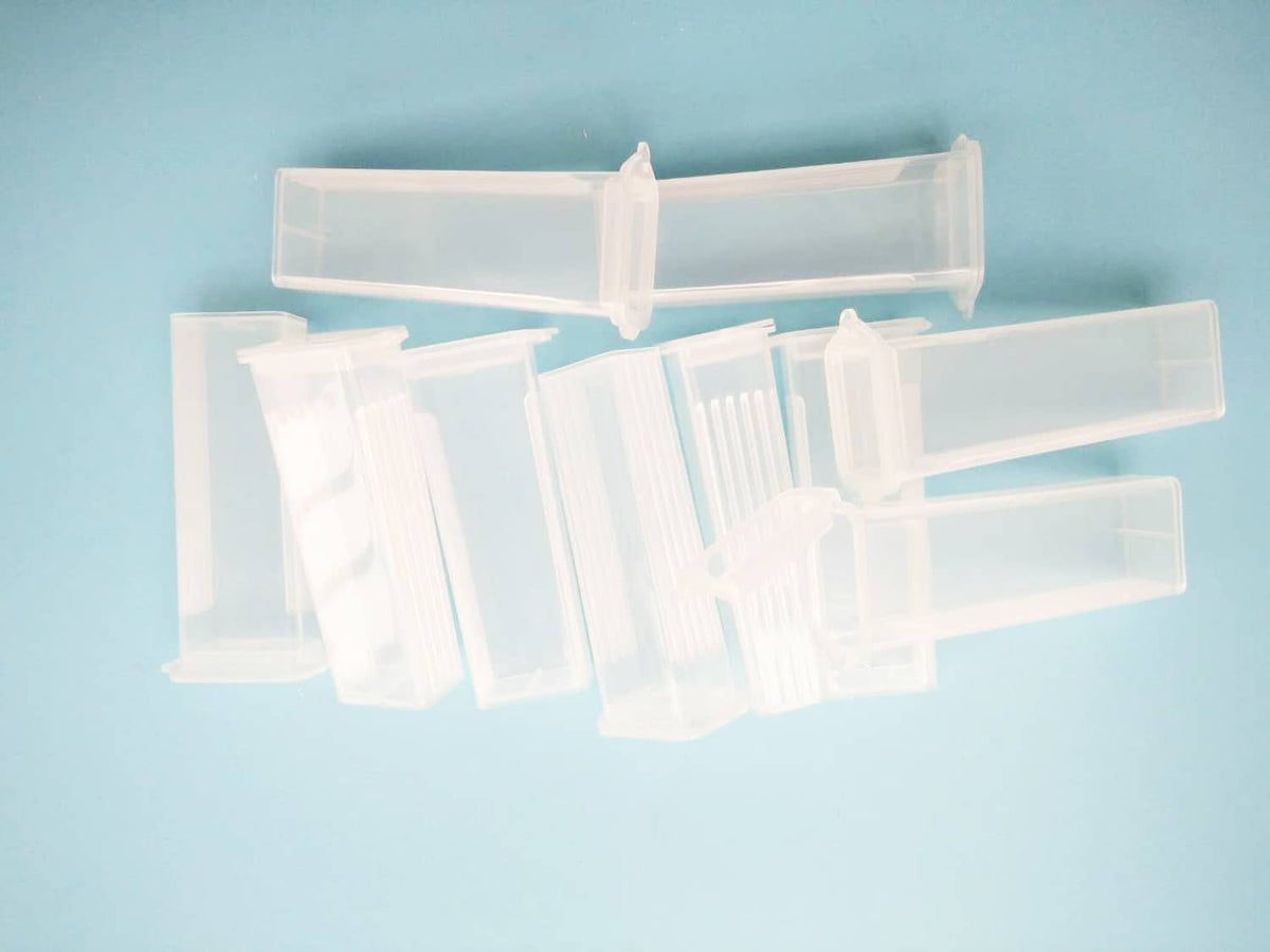 Clear plastic microscope slide holder box with several compartments for rectangular slides