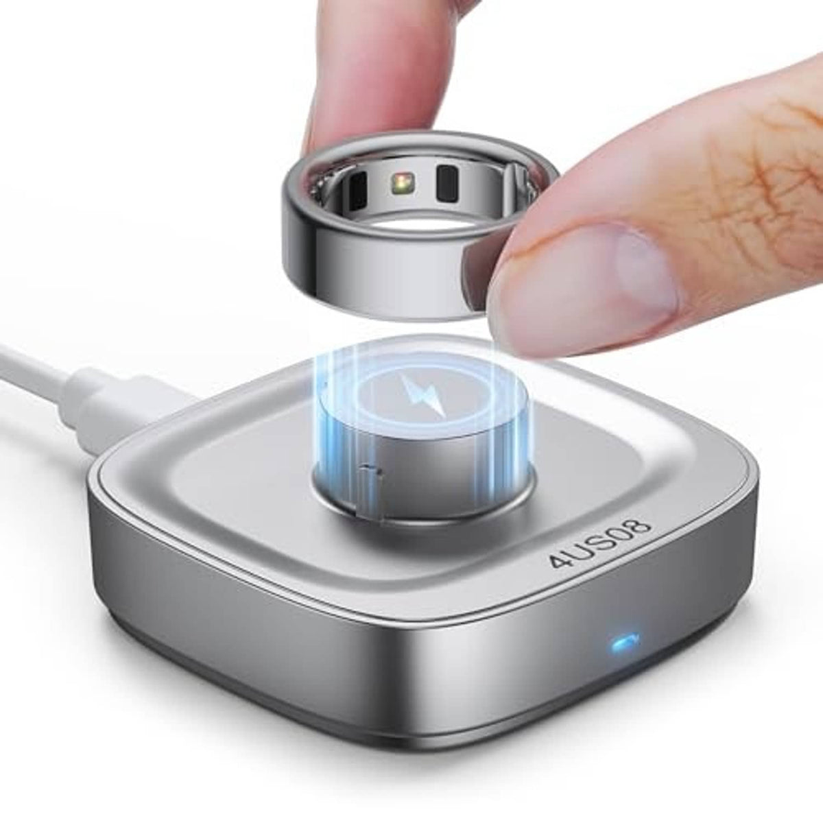 Glossy silver charging dock with ring seated in the holder and blue indicator light