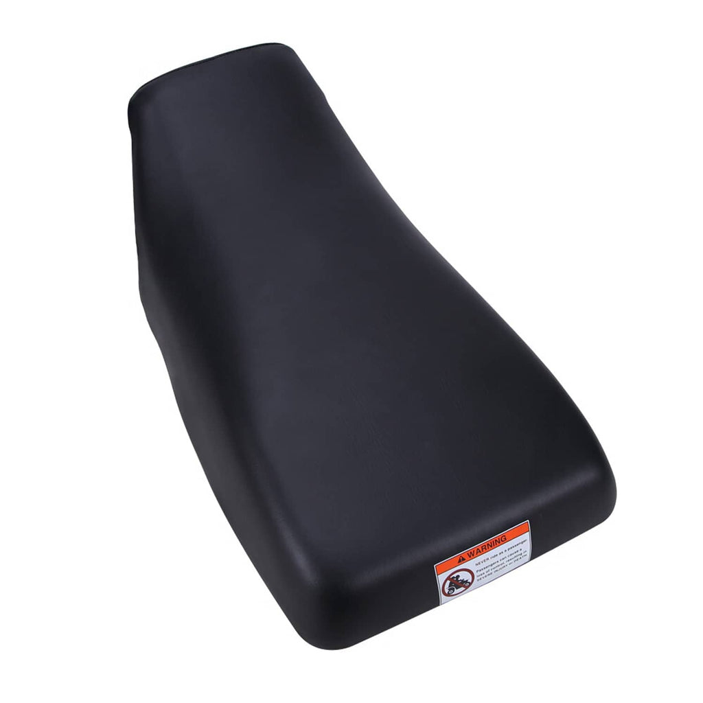 Black ATV seat cushion with rounded side profile and front warning label
