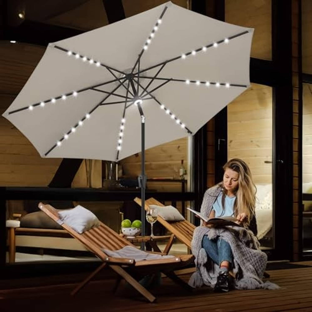 Taupe 9 ft patio umbrella with lit center LED spokes over outdoor lounge chairs