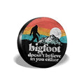 Black round RV spare tire cover with Bigfoot graphic and moon backdrop