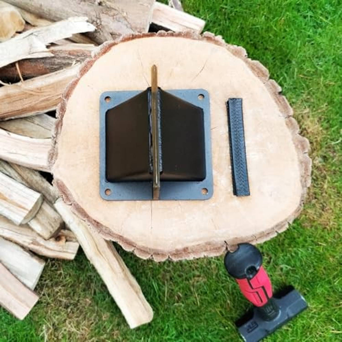 Log splitting wedge mounted on a cut log, with black base and yellow metal blade