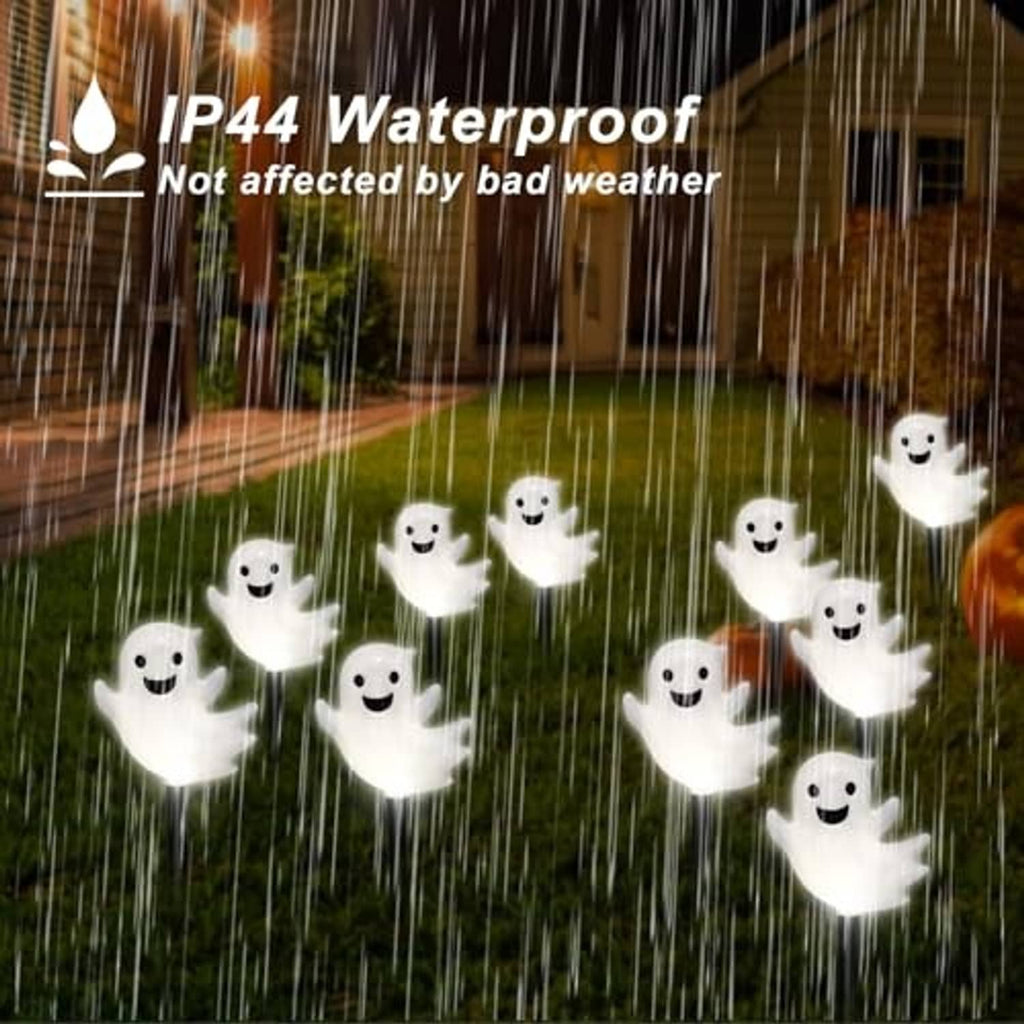 Glowing white ghost solar stake lights with smiling faces in rain