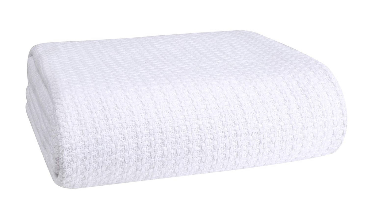 White cotton bed blanket, folded with waffle-texture weave.