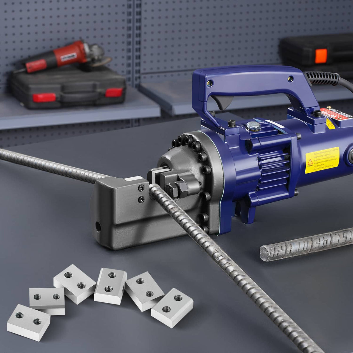 Blue electric rebar cutter head with several steel gray jaw blade blocks