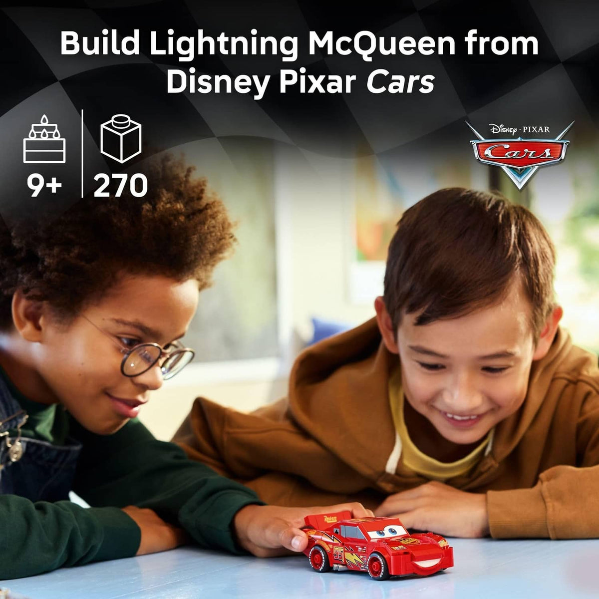 Red buildable race car toy with Lightning McQueen-style face, child holding the car