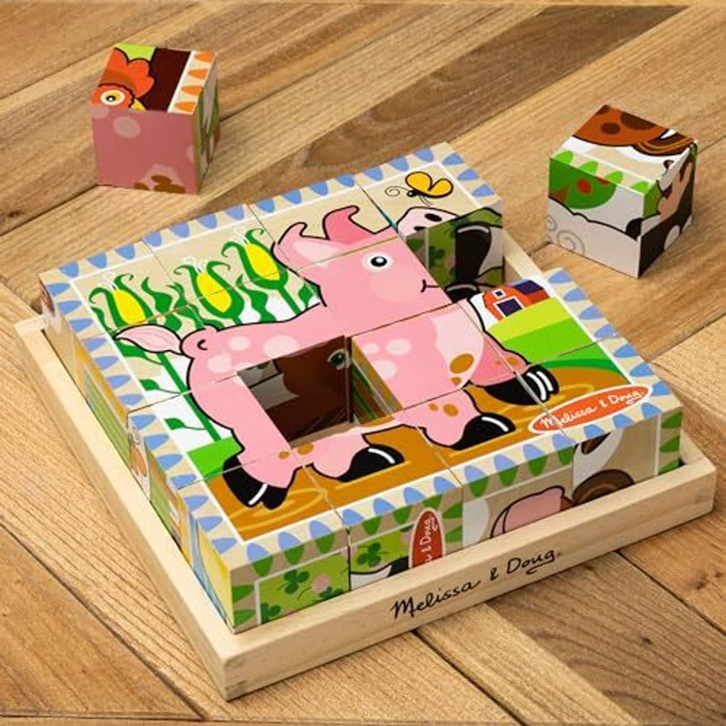 Wooden farm cube puzzle tray with assembled animal pieces and matching loose cubes