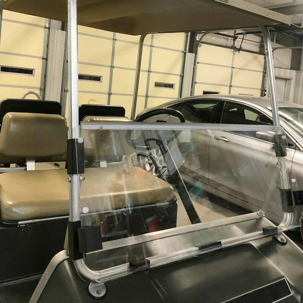 Clear folding windshield panel installed inside a garage on a golf cart