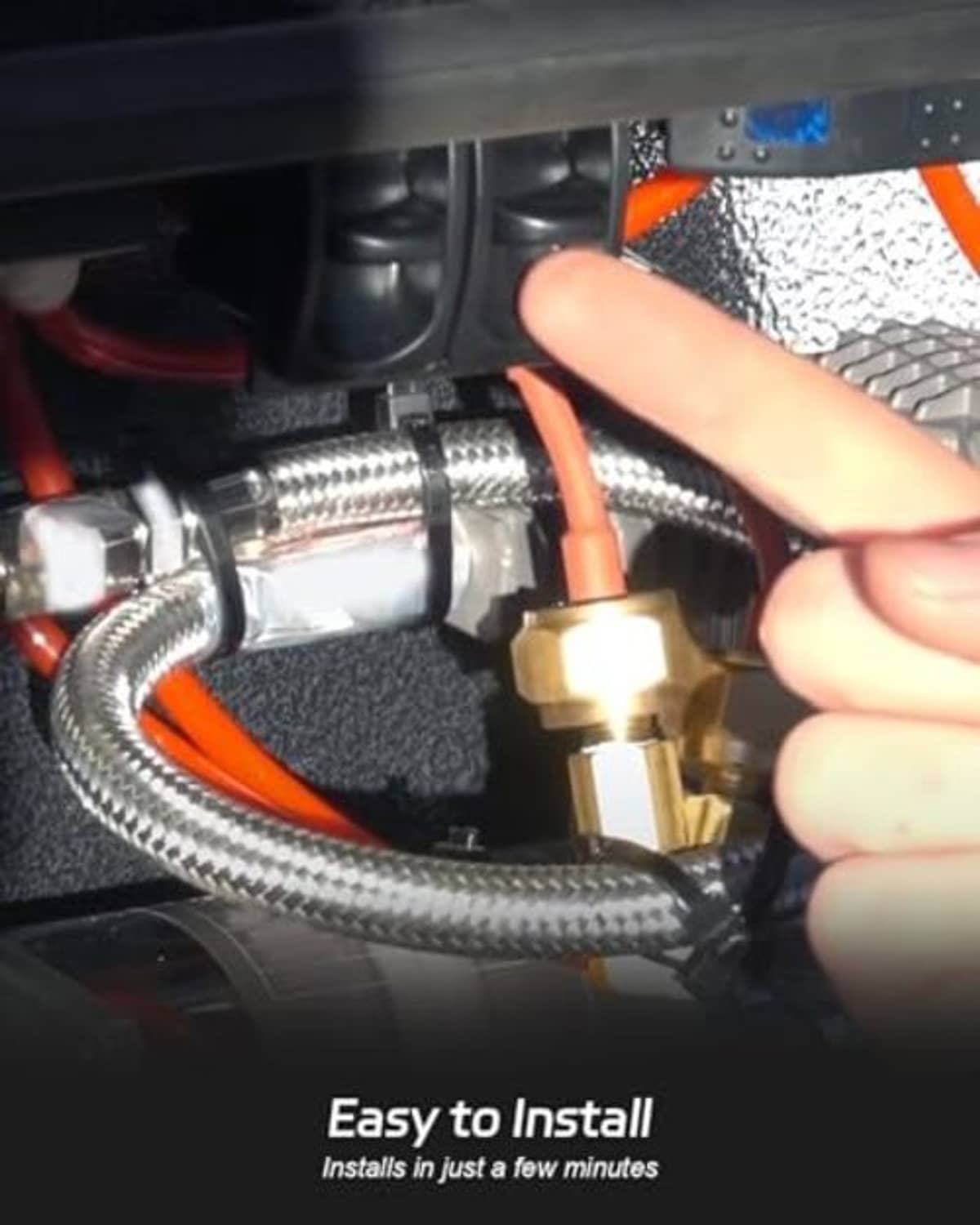 Black manual paddle valve switch installed near brass fittings with an installing hand.