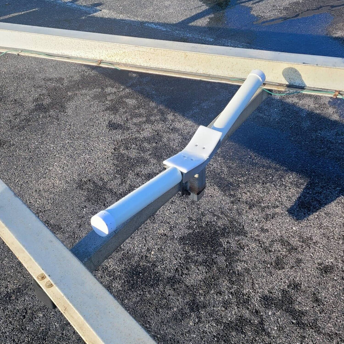 Bow rest centering V guide mounted on trailer crossbeam with white PVC tubes