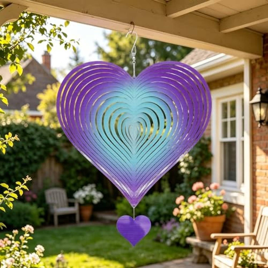 Heart wind spinner with purple-blue gradient rings and small heart charm, hanging outdoors near porch.