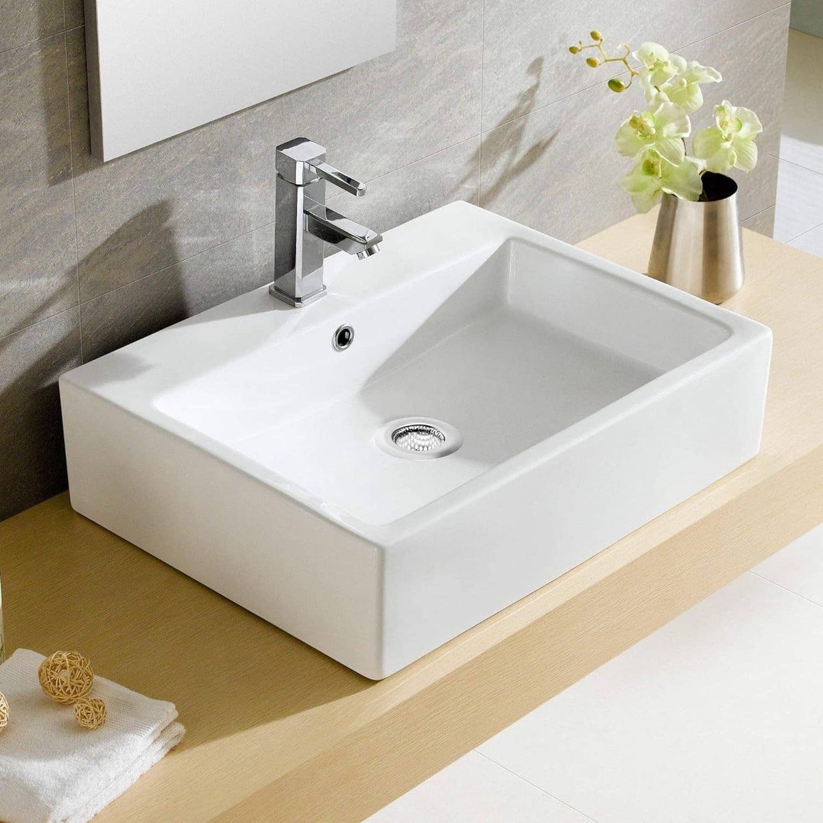 Bathroom sink with round stainless steel drain strainer in center drain