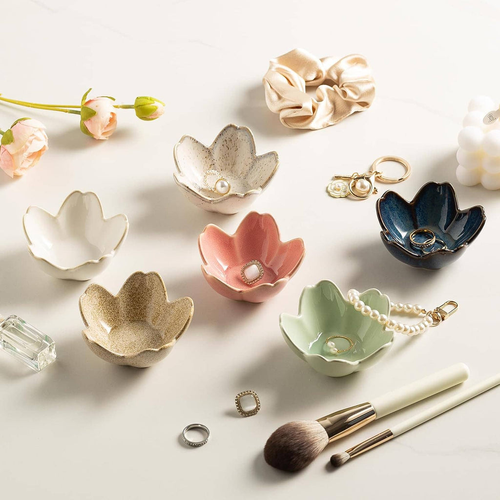 Assorted ceramic flower trinket dishes, including a dark blue jewelry tray