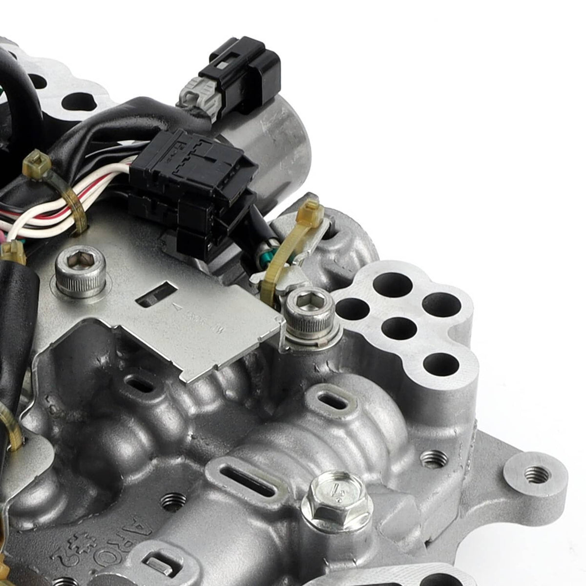 CVT transmission valve body close-up with black wiring connectors and silver metal cover