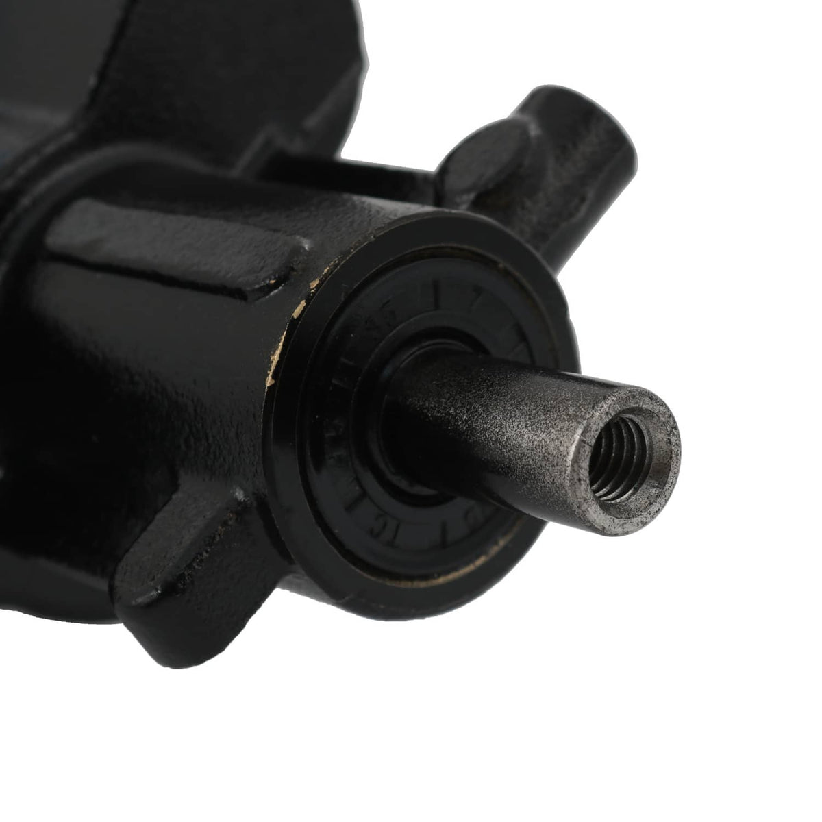 Close-up of black pump head with threaded inlet fitting and circular seal housing