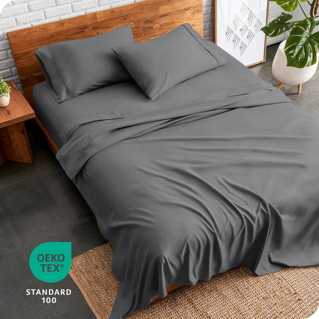 Grey split king bed linen set with pillowcases and fitted sheet on the bed