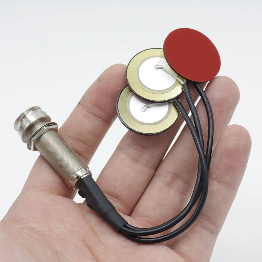 Piezo contact pickup set held in hand with three red/gold pads and black wires