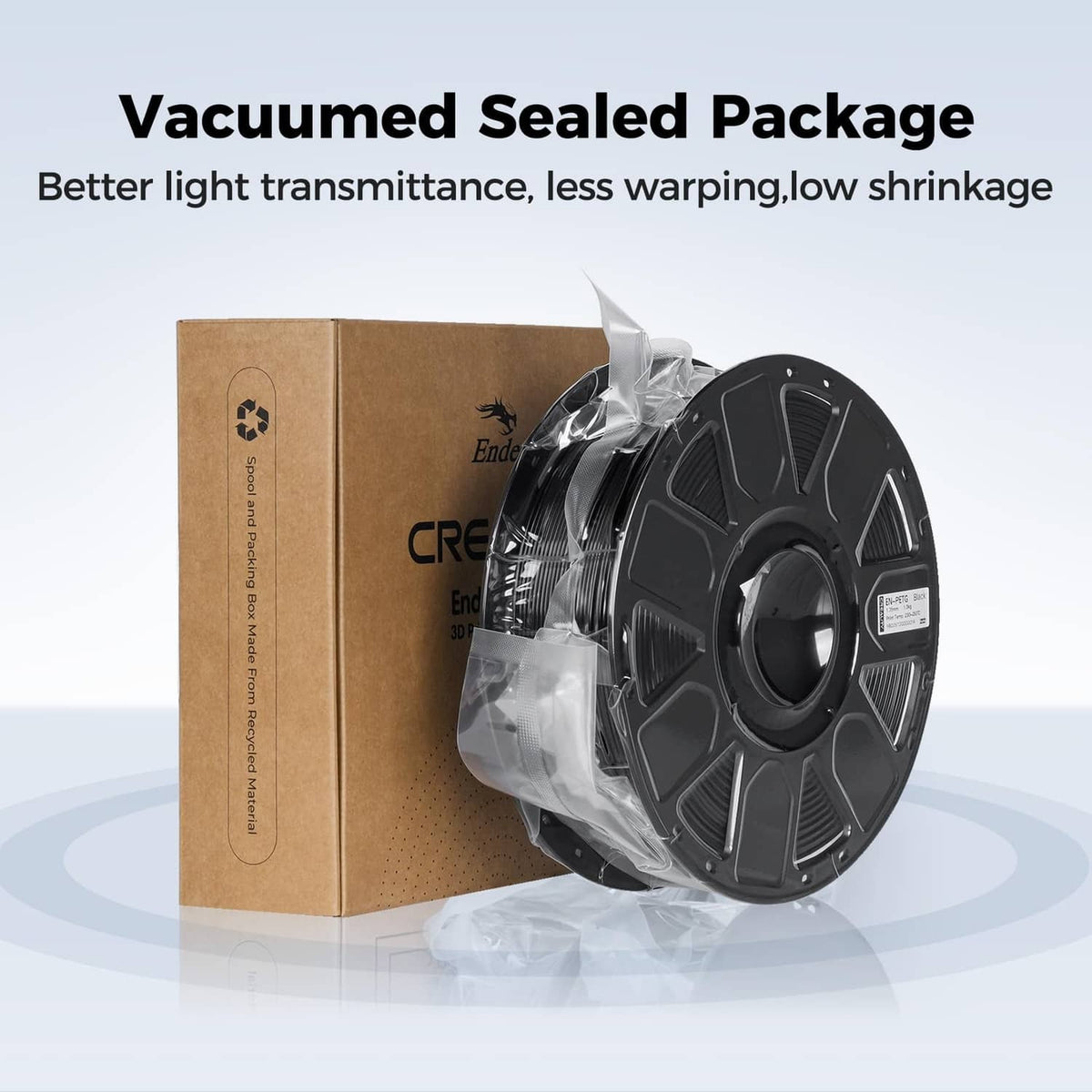 Vacuum-sealed filament spool in clear bag with a cardboard shipping box