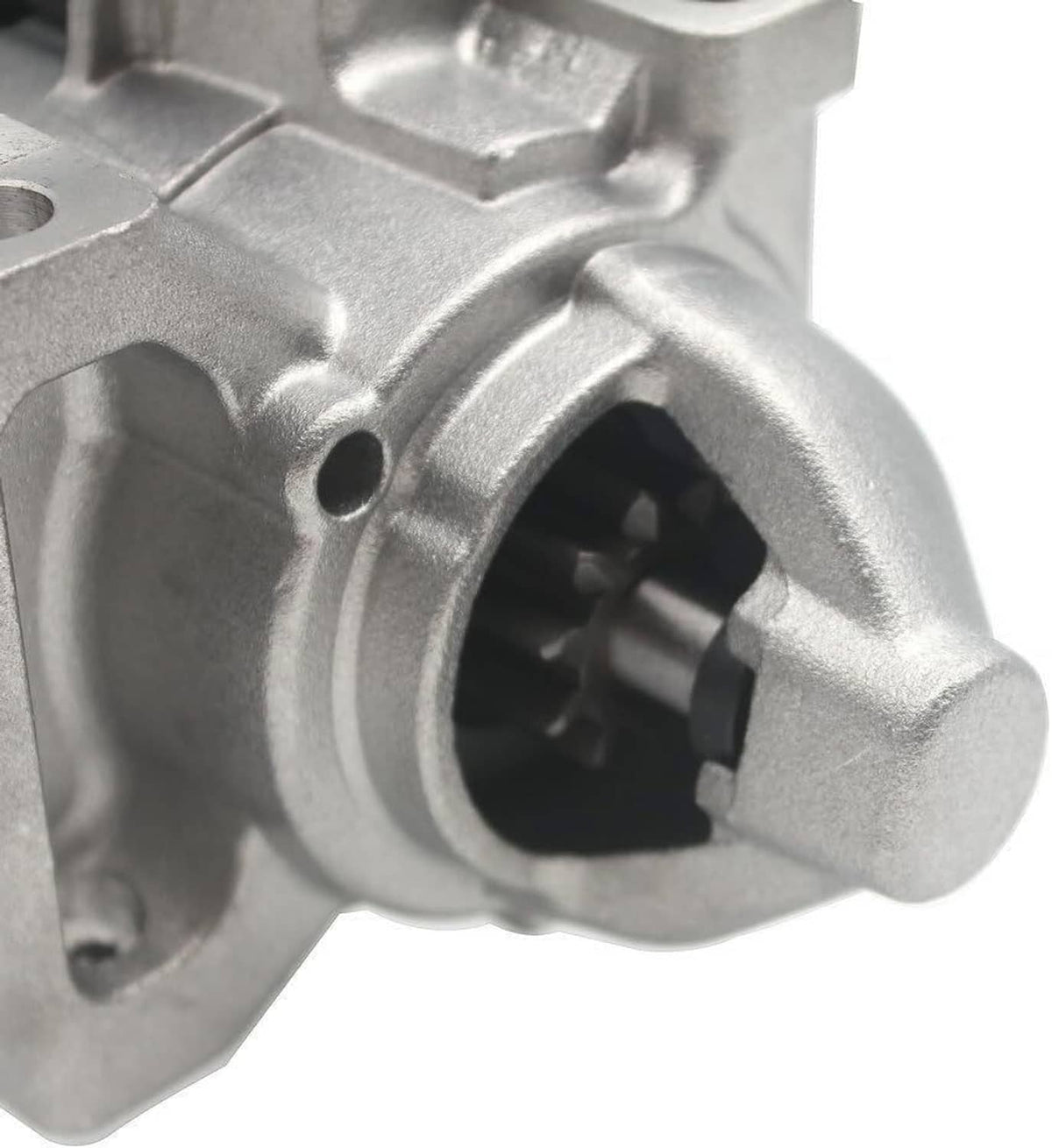 Starter motor front opening with visible gear inside the silver housing