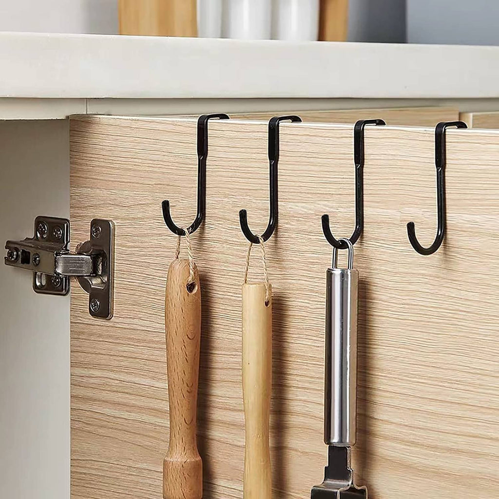 Black shower door hooks installed on cabinet door, holding hanging items