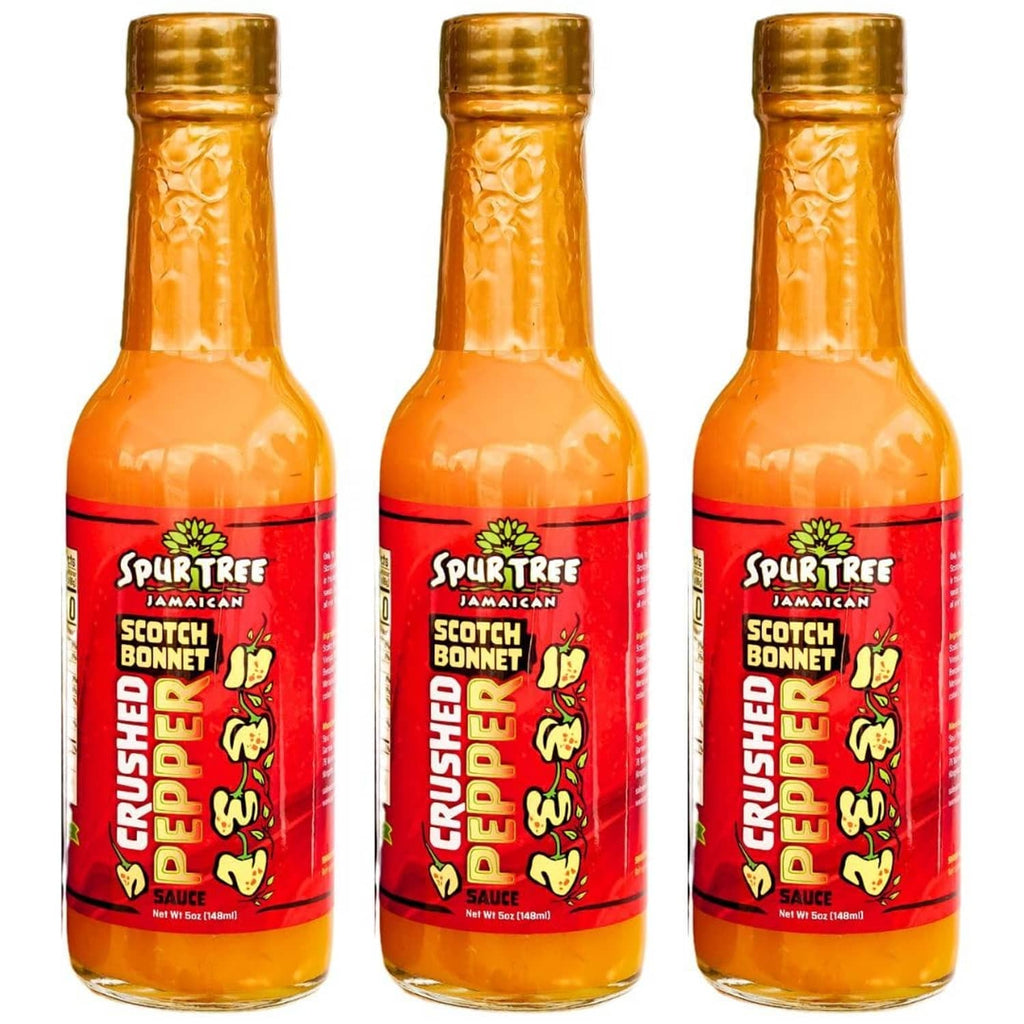 Spur Tree Jamaican scotch bonnet pepper sauce bottles, three glass bottles with red labels