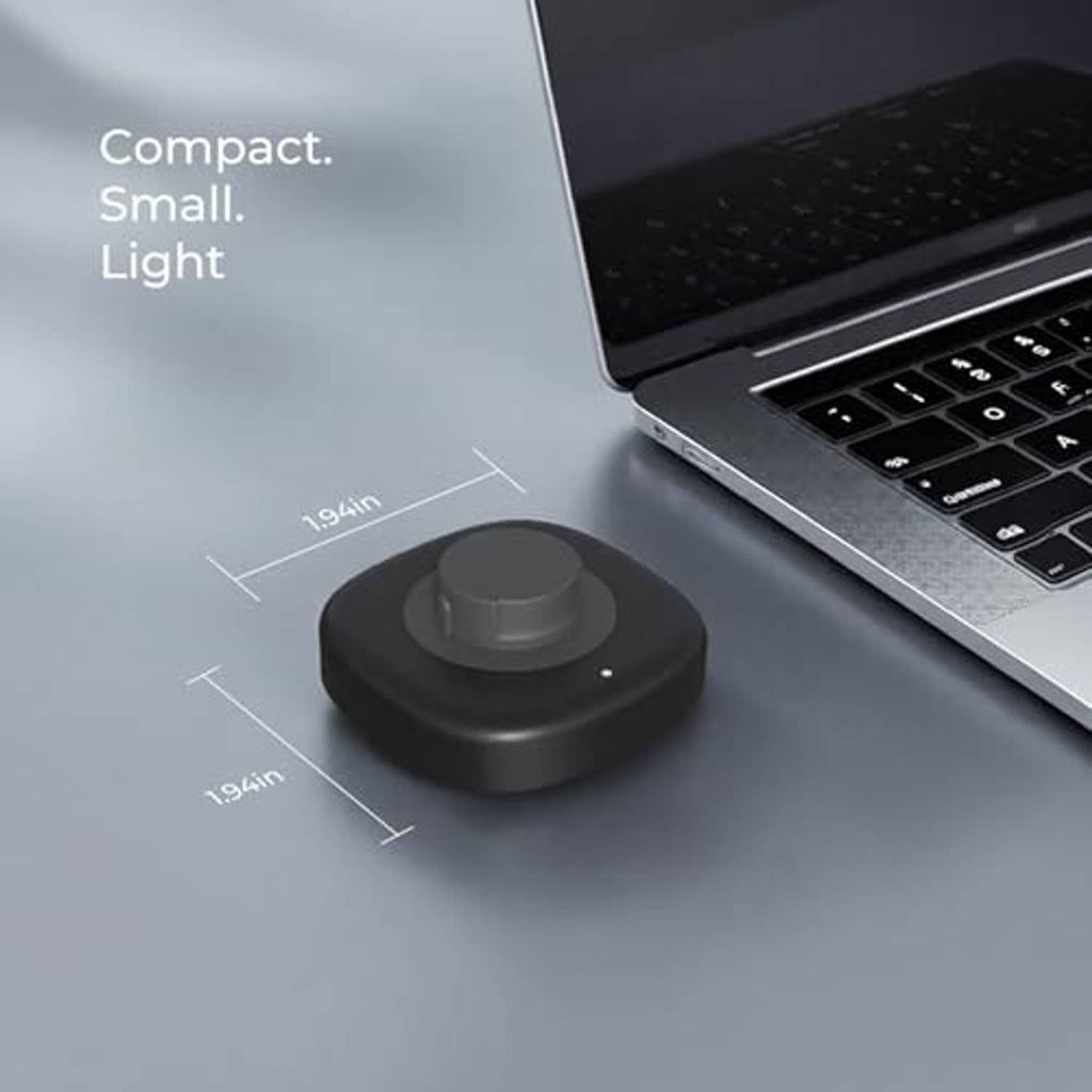 Compact wireless ring charging dock on desk with size markings