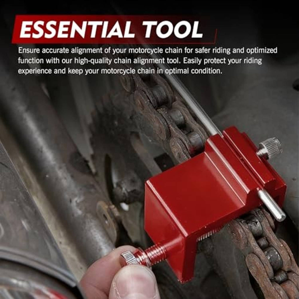 Red chain straightener tool clamped on motorcycle chain with threaded screw