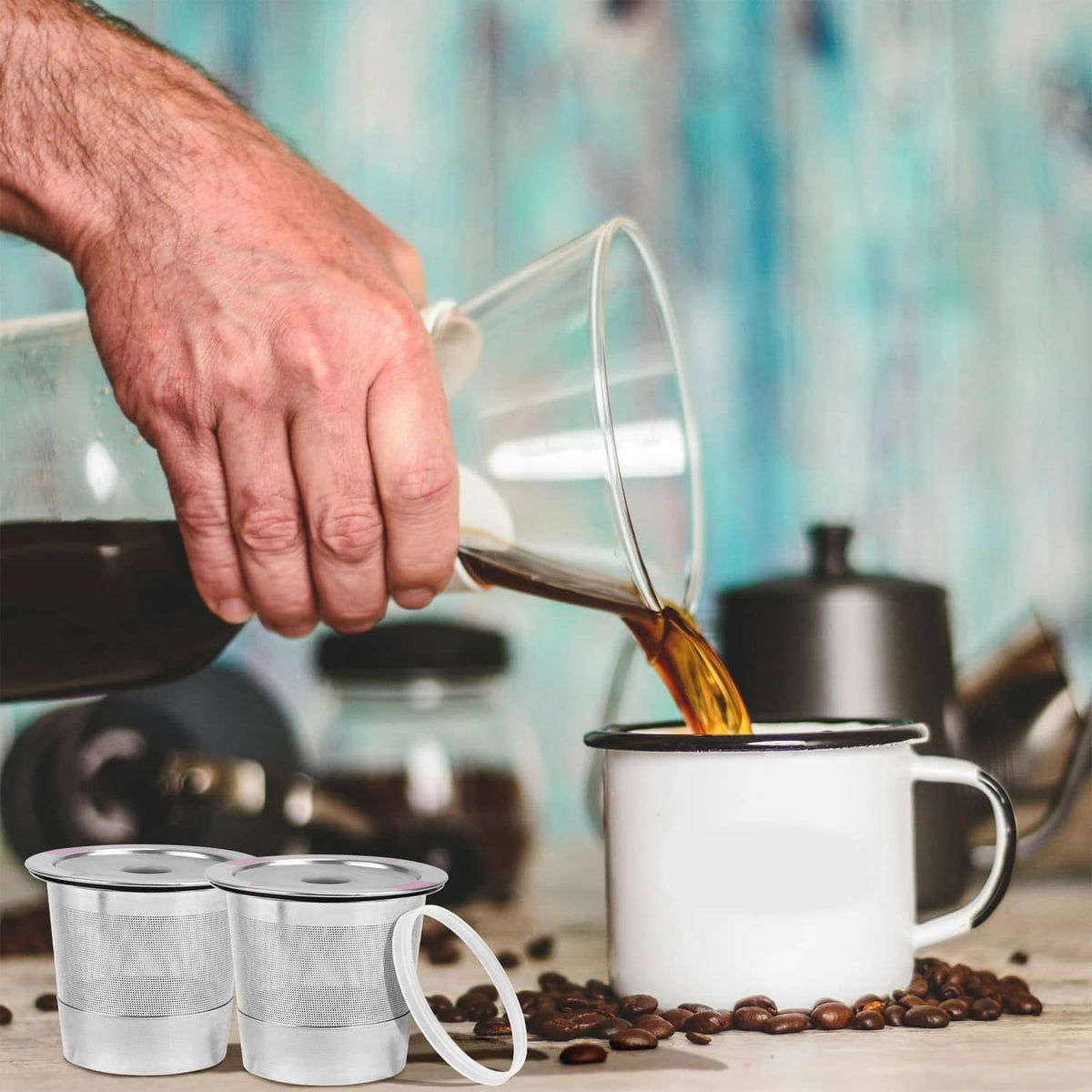 Hand pouring coffee into stainless steel refillable cups with vented lids