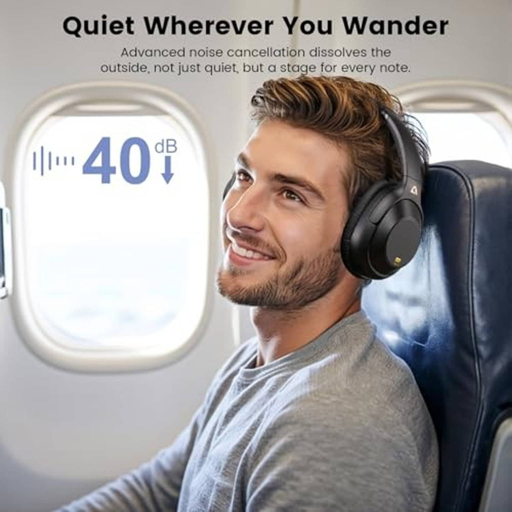 Over-ear headphones on a man seated in a gray shirt