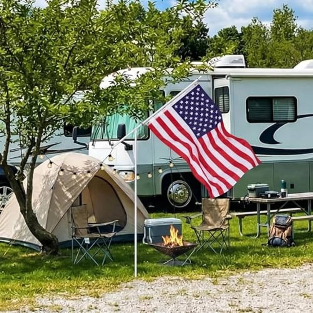 American flag on a white telescoping pole with ground stake, displayed outdoors