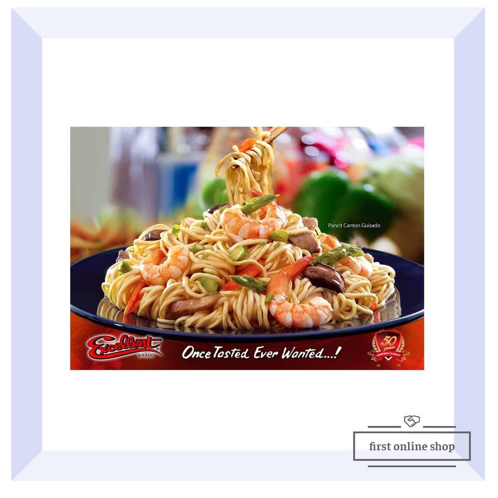 Plate of pancit noodles with shrimp, herbs, and vegetables