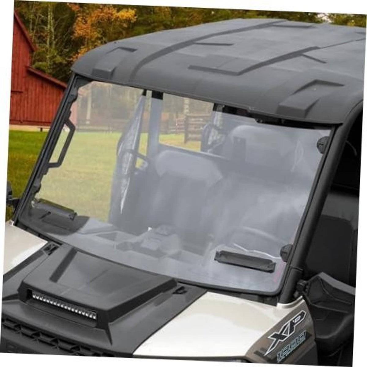 Front UTV windshield with dark frame and clear tinted panel, installed on vehicle