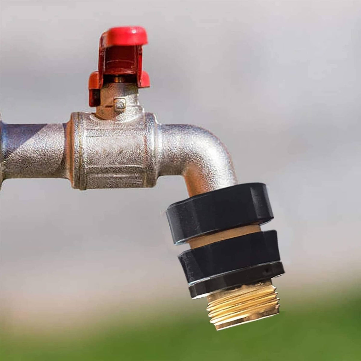 Gold quick connector on a metal spout with black collar and threaded outlet