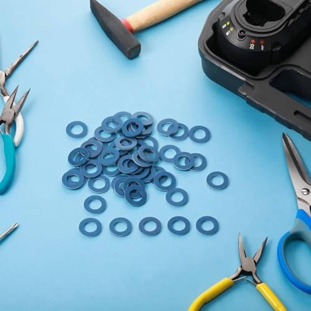 Blue metal crush washers scattered, flat rings with center holes for oil drain plugs