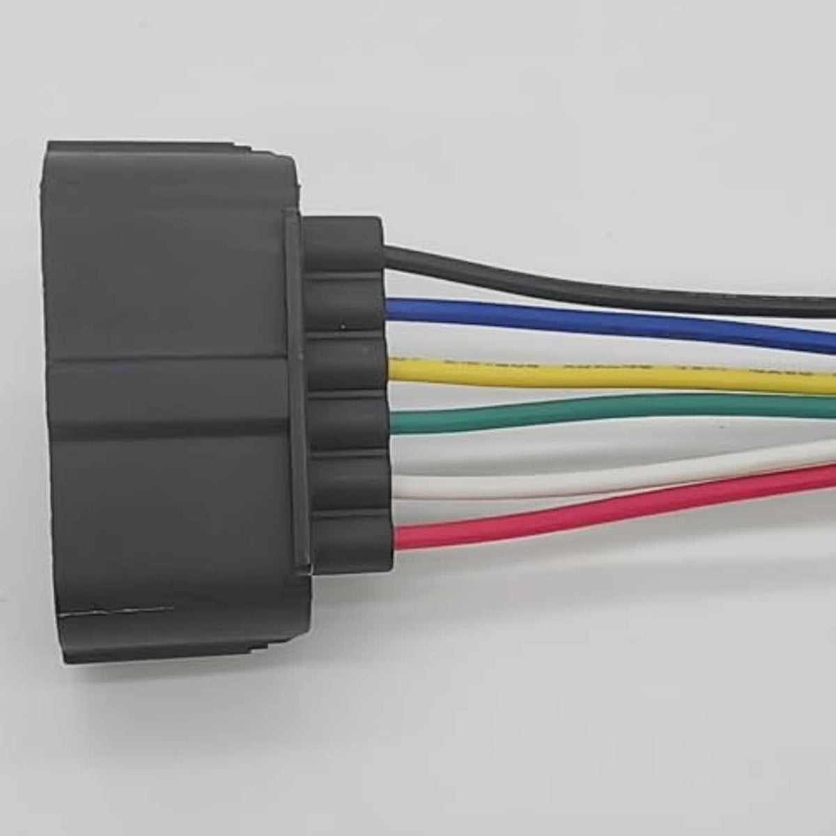 Black connector housing with red, blue, yellow, and green wires