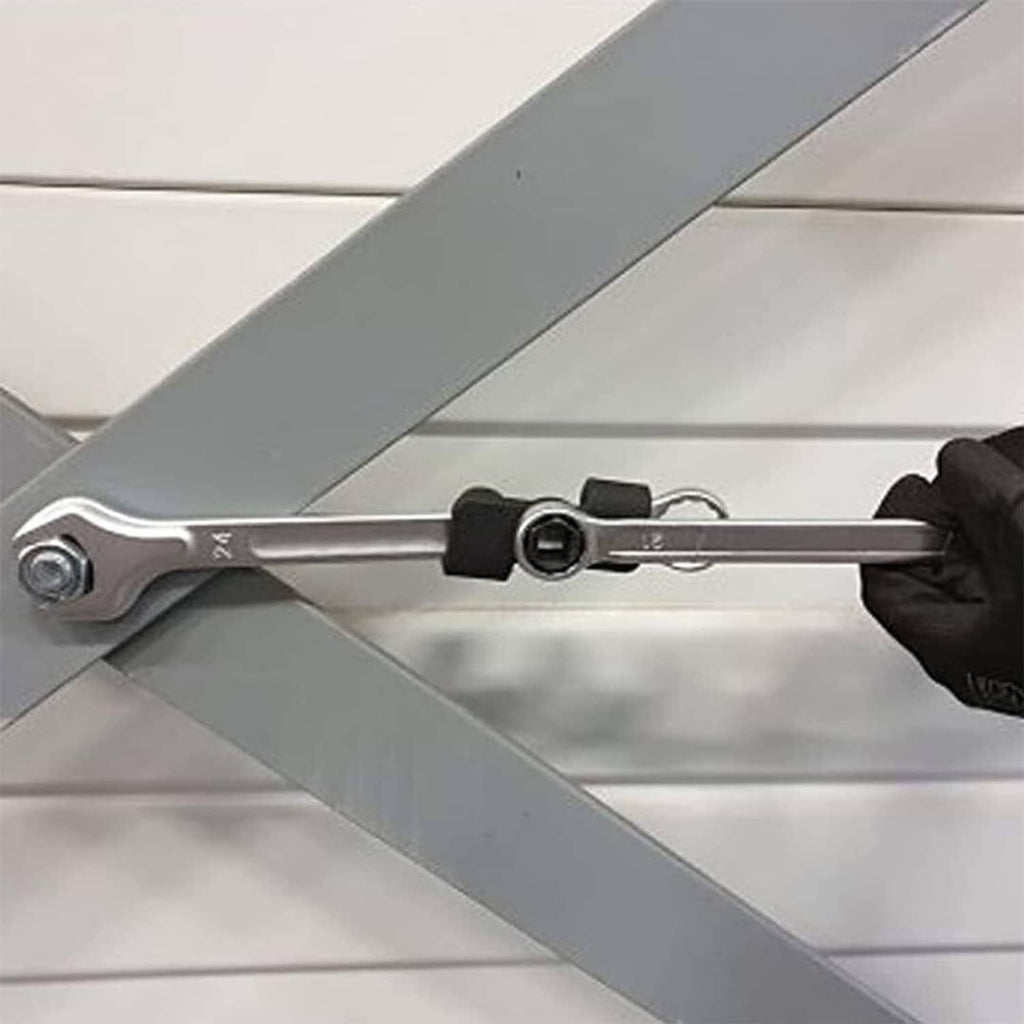 Socket wrench with black extender adapter engaged on a metal beam