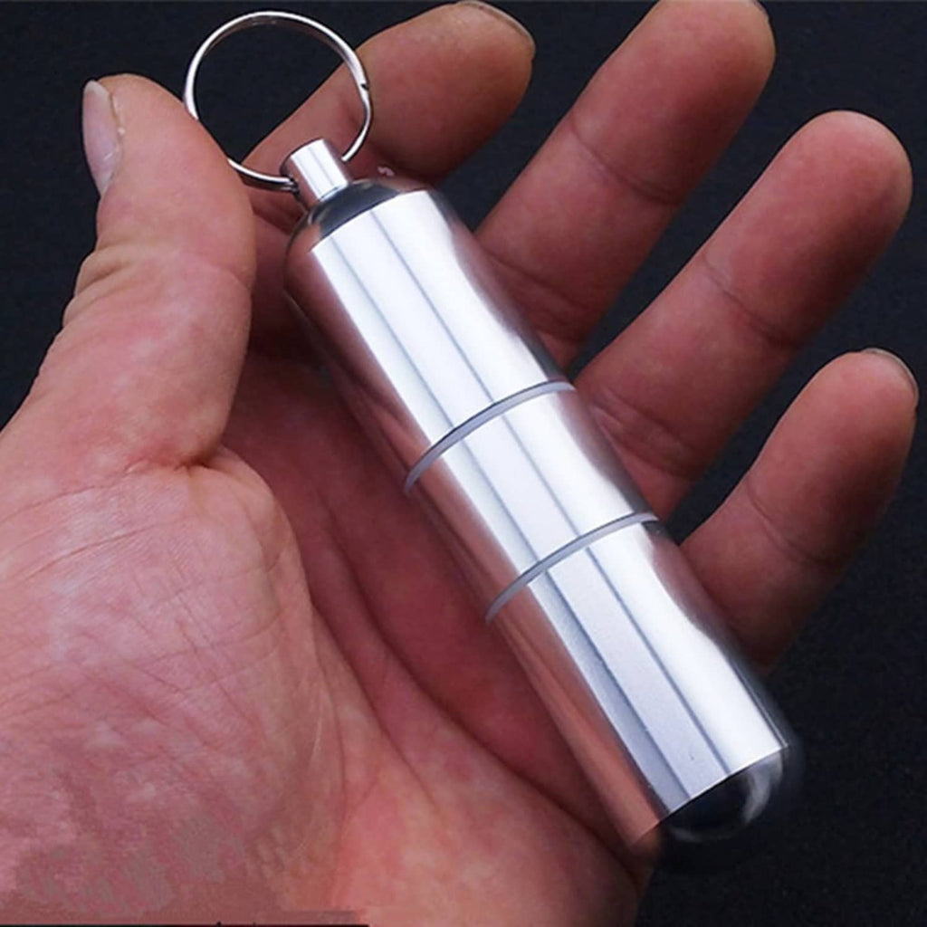 Silver cigarette case keyring held in palm, sleek metal tube design